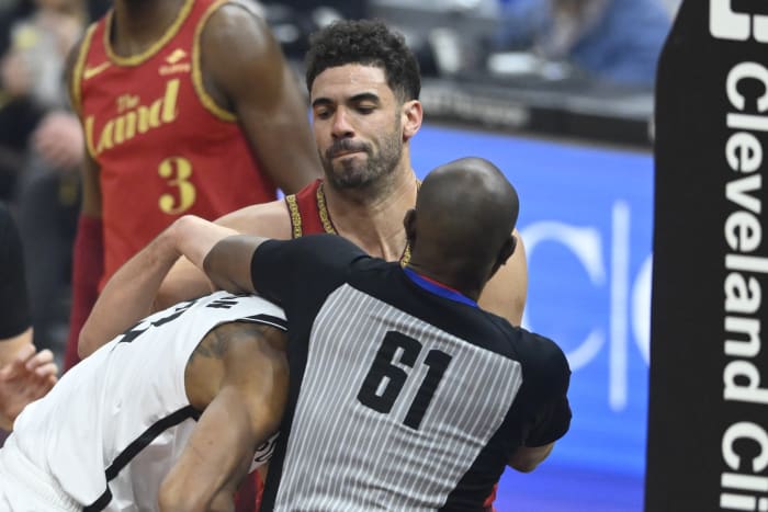 NBA referee Courtney Kirkland (61) breaks up a scuffle between Brooklyn Nets center Nic Claxton (33) and Cleveland Cavaliers forward Georges Niang (20)